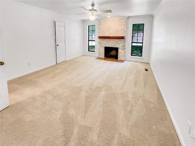 unfurnished living room with ceiling fan, carpet flooring, baseboards, and crown molding