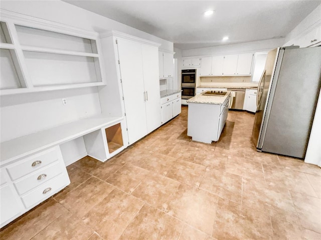 kitchen with appliances with stainless steel finishes, open shelves, white cabinets, a center island, and recessed lighting