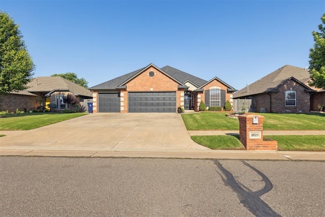 2825 Busheywood Dr, Yukon, OK 73099 - view of front of property featuring a front lawn, an attached garage, brick siding, and concrete driveway
