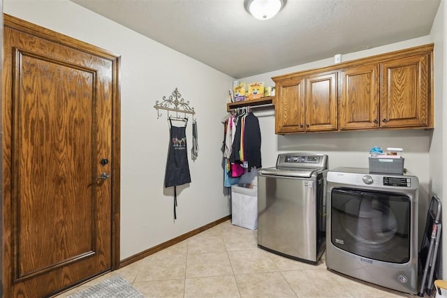 2825 Busheywood Dr, Yukon, OK 73099 - laundry area with cabinet space, washer and dryer, light tile patterned flooring, and baseboards