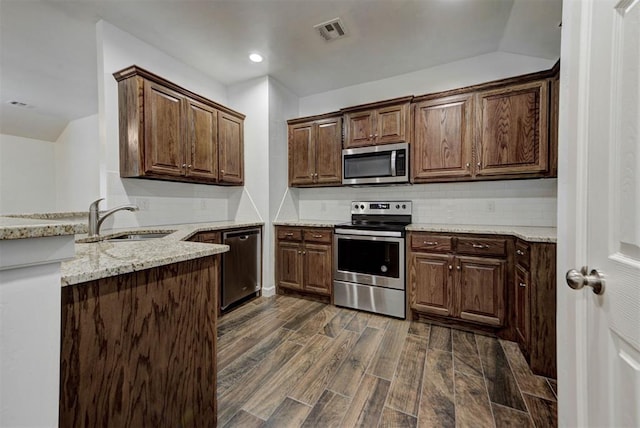 316 SW 4th Pl, Newcastle, OK 73065 - kitchen with stainless steel appliances, a sink, dark wood-style flooring, light stone counters, and decorative backsplash