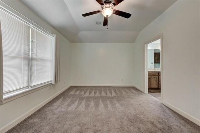 316 SW 4th Pl, Newcastle, OK 73065 - empty room with light carpet, a ceiling fan, vaulted ceiling, and baseboards
