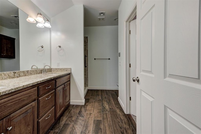 316 SW 4th Pl, Newcastle, OK 73065 - bathroom with vanity, toilet, baseboards, a shower stall, and wood finished floors