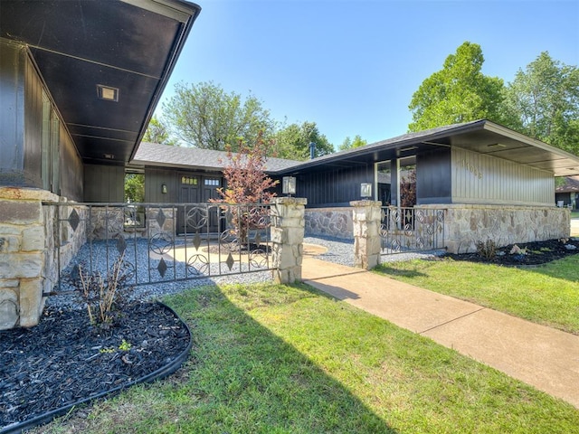 11008 Blue Sage Rd, Oklahoma City, OK 73120 - view of side of property featuring stone siding and a yard