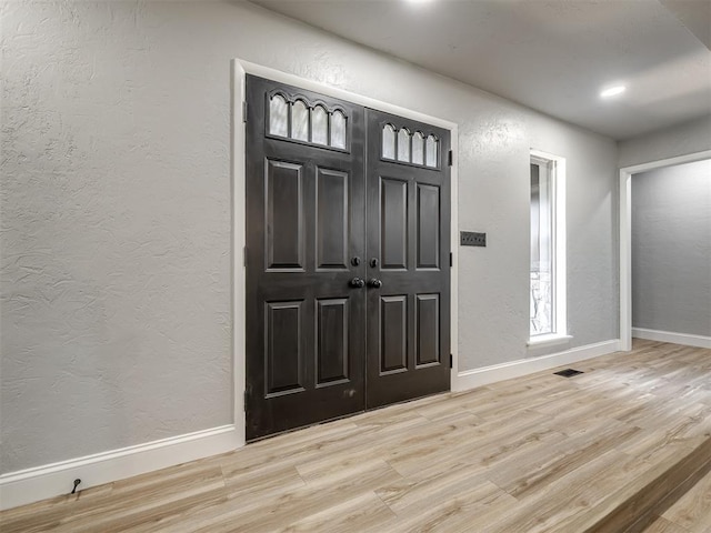 11008 Blue Sage Rd, Oklahoma City, OK 73120 - foyer entrance featuring light wood-type flooring, baseboards, a textured wall, and recessed lighting