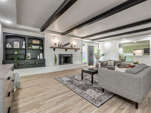 11008 Blue Sage Rd, Oklahoma City, OK 73120 - living room featuring light wood-type flooring, a fireplace, and beamed ceiling