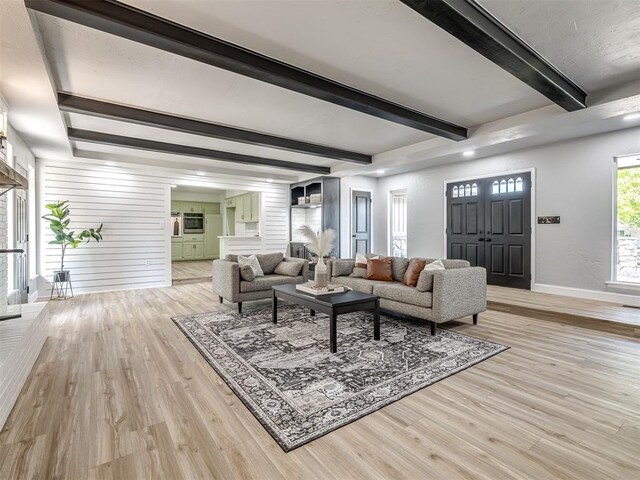 11008 Blue Sage Rd, Oklahoma City, OK 73120 - living area with baseboards, light wood-style flooring, and beamed ceiling