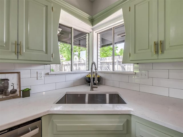 11008 Blue Sage Rd, Oklahoma City, OK 73120 - kitchen featuring a sink, green cabinetry, dishwasher, decorative backsplash, and light stone countertops