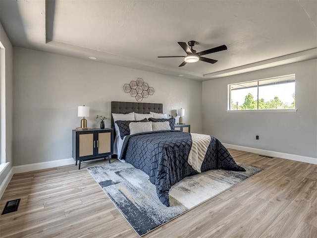 11008 Blue Sage Rd, Oklahoma City, OK 73120 - bedroom with baseboards, wood finished floors, and a raised ceiling