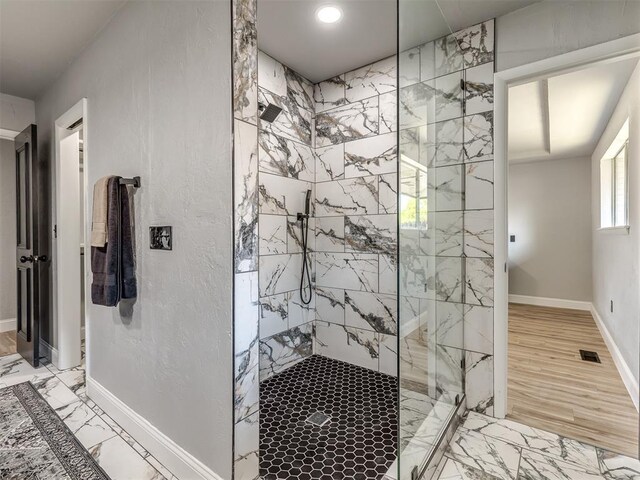 11008 Blue Sage Rd, Oklahoma City, OK 73120 - bathroom featuring a marble finish shower, baseboards, marble finish flooring, and recessed lighting