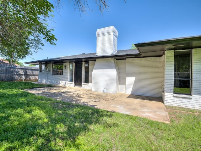 11008 Blue Sage Rd, Oklahoma City, OK 73120 - rear view of house with a patio area, brick siding, and a chimney