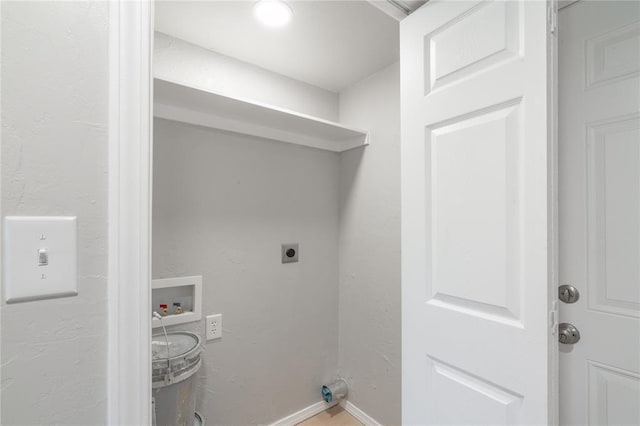 clothes washing area featuring electric dryer hookup, baseboards, and washer hookup