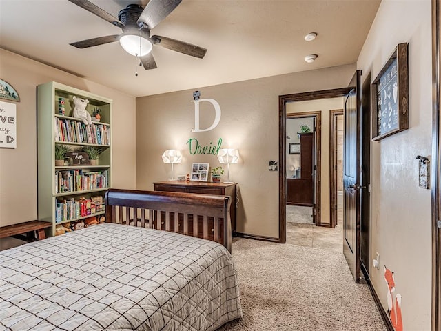 bedroom with light colored carpet, baseboards, and ceiling fan