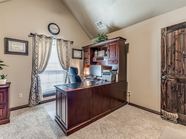 office area with light colored carpet, vaulted ceiling, and baseboards