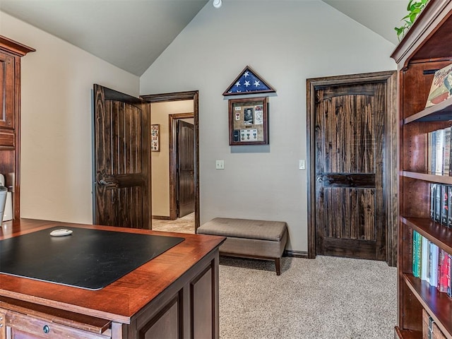 office area with lofted ceiling, light carpet, and baseboards