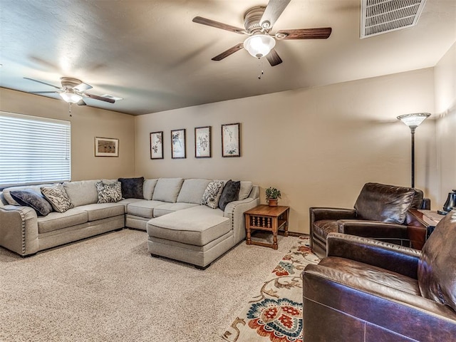 living room with a ceiling fan and carpet floors