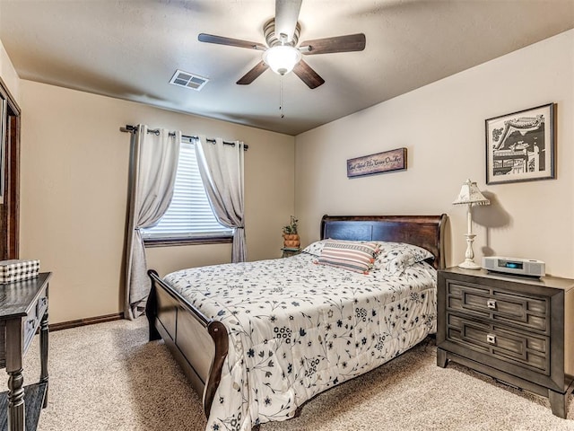 bedroom featuring light carpet, baseboards, and ceiling fan