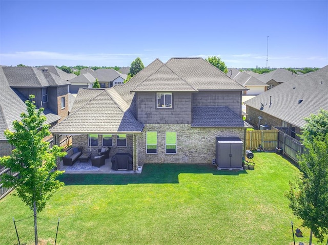back of property with a patio, a storage unit, a residential view, and a shingled roof