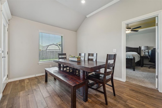 dining room with vaulted ceiling, dark wood-type flooring, baseboards, ceiling fan, and crown molding