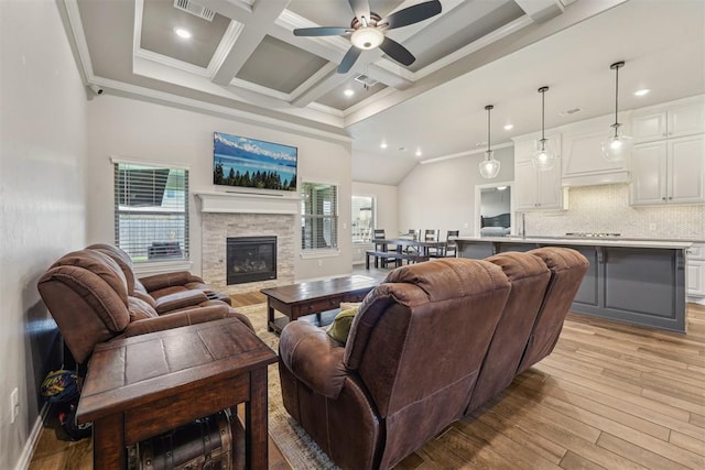 living room featuring ornamental molding, ceiling fan, light wood-style flooring, recessed lighting, and beam ceiling
