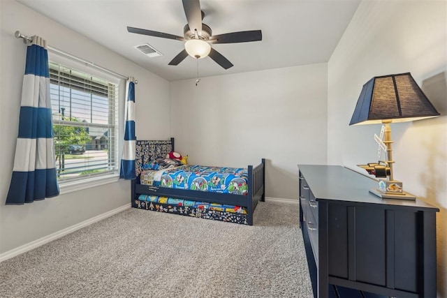 carpeted bedroom with baseboards and a ceiling fan