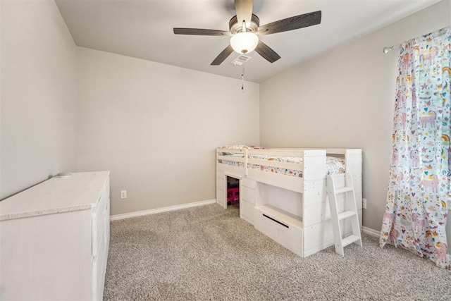 unfurnished bedroom with light carpet, a ceiling fan, and baseboards
