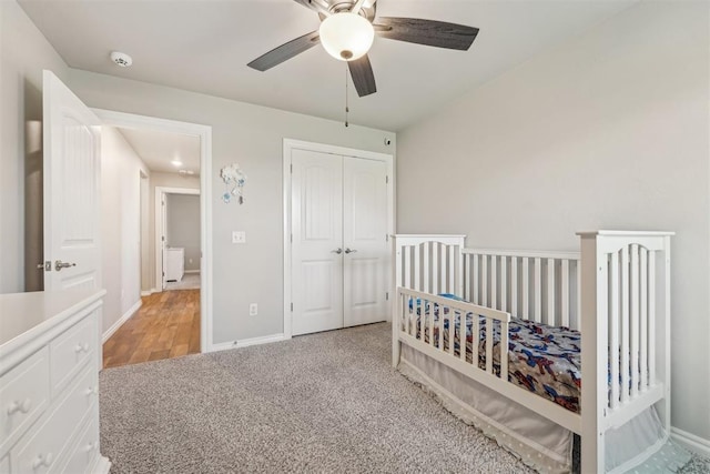 carpeted bedroom with a closet, ceiling fan, and baseboards