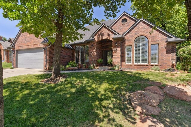 13500 Creekside Dr, Oklahoma City, OK 73131 - traditional home with brick siding, driveway, a garage, and a front lawn
