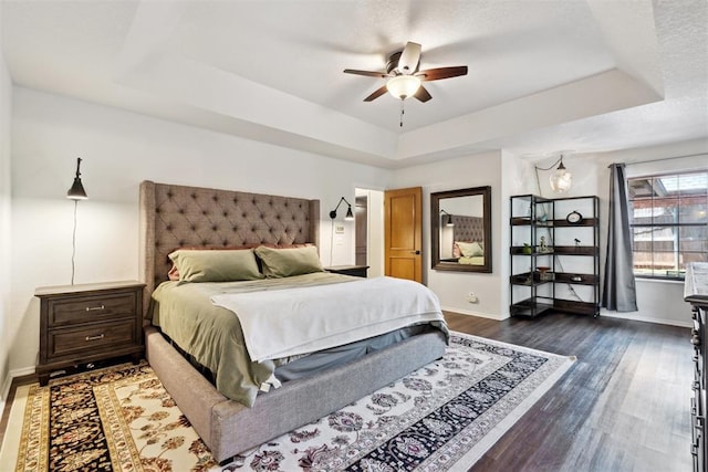13500 Creekside Dr, Oklahoma City, OK 73131 - bedroom with a raised ceiling, dark wood-style floors, baseboards, and ceiling fan