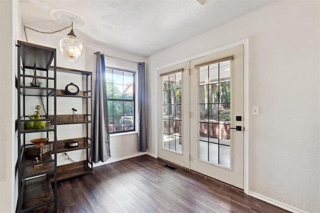 13500 Creekside Dr, Oklahoma City, OK 73131 - doorway to outside with dark wood finished floors and baseboards