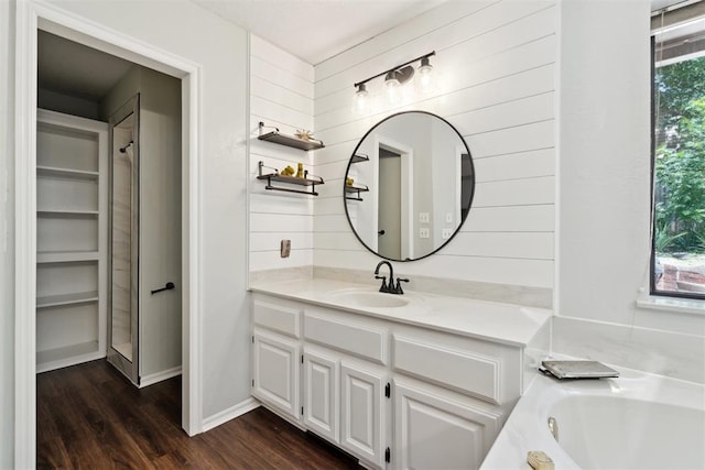 13500 Creekside Dr, Oklahoma City, OK 73131 - bathroom with vanity, wood finished floors, and a tub