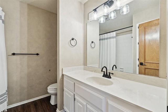 13500 Creekside Dr, Oklahoma City, OK 73131 - full bathroom with toilet, wood finished floors, vanity, baseboards, and a shower with shower curtain