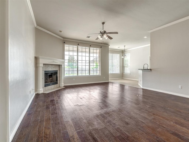 16104 Ledge Ln, Edmond, OK 73013 - unfurnished living room with a ceiling fan, ornamental molding, a fireplace, baseboards, and dark wood finished floors