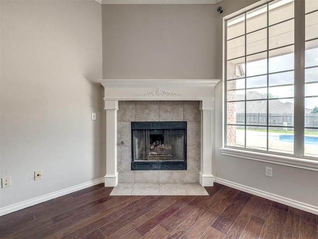 16104 Ledge Ln, Edmond, OK 73013 - detailed view of wood finished floors, a tile fireplace, and baseboards