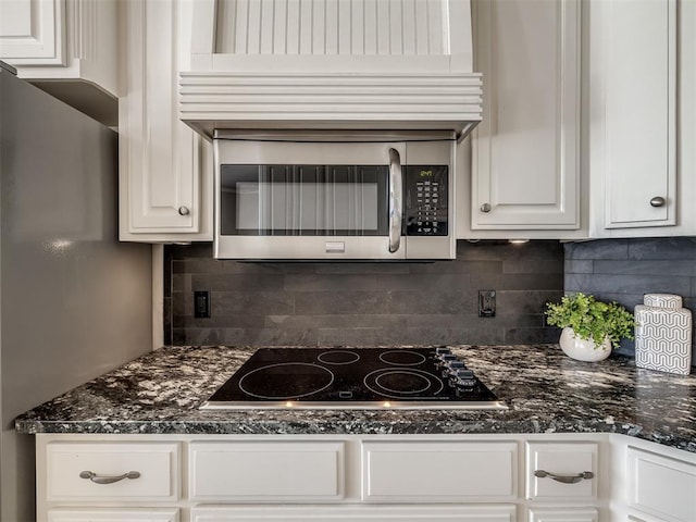 16104 Ledge Ln, Edmond, OK 73013 - kitchen featuring black electric stovetop, white cabinets, backsplash, and stainless steel microwave
