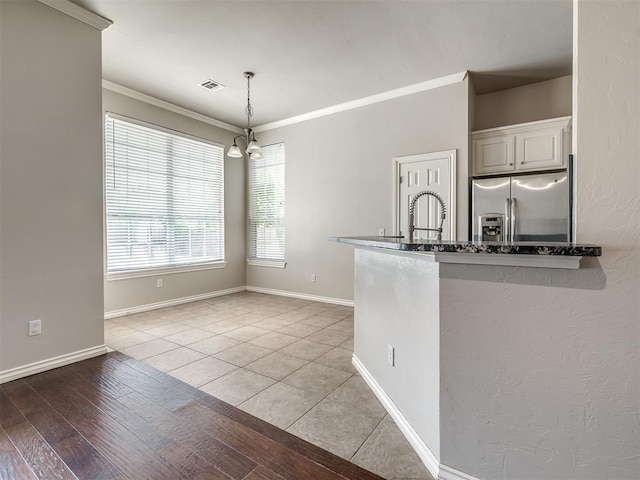 16104 Ledge Ln, Edmond, OK 73013 - kitchen featuring stainless steel refrigerator with ice dispenser, a chandelier, ornamental molding, a sink, and decorative light fixtures