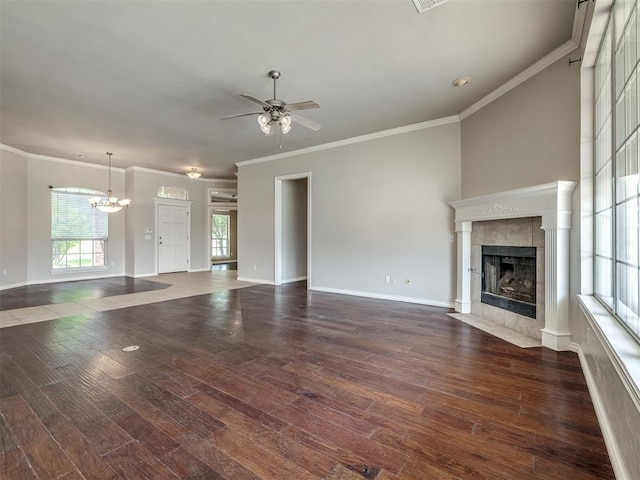 16104 Ledge Ln, Edmond, OK 73013 - unfurnished living room with ornamental molding, ceiling fan, a fireplace, dark wood finished floors, and a chandelier