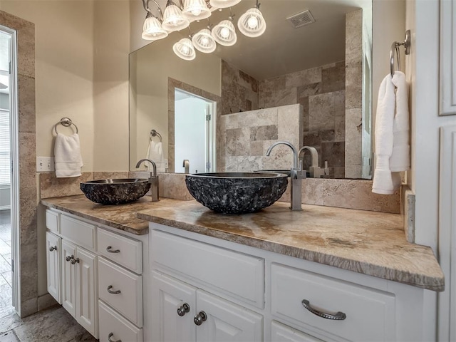 16104 Ledge Ln, Edmond, OK 73013 - bathroom featuring double vanity and a chandelier