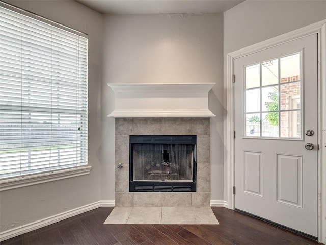 16104 Ledge Ln, Edmond, OK 73013 - detailed view of a tiled fireplace, wood finished floors, and baseboards