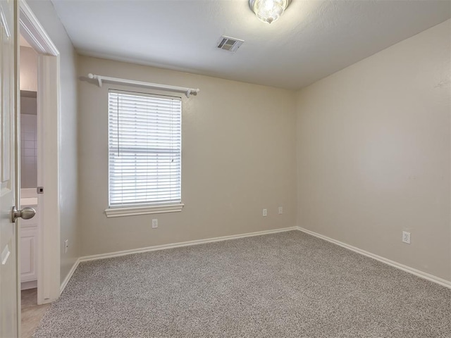 16104 Ledge Ln, Edmond, OK 73013 - empty room with light carpet, plenty of natural light, and baseboards