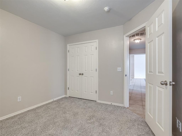 16104 Ledge Ln, Edmond, OK 73013 - unfurnished bedroom with carpet flooring, baseboards, and a closet