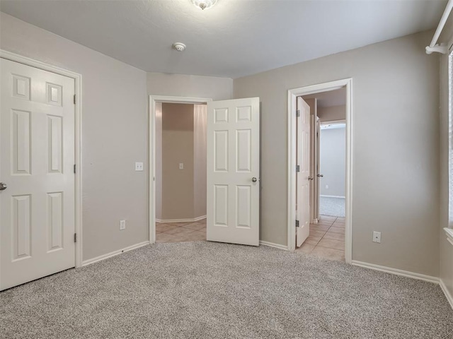 16104 Ledge Ln, Edmond, OK 73013 - unfurnished bedroom with light colored carpet, baseboards, and light tile patterned floors