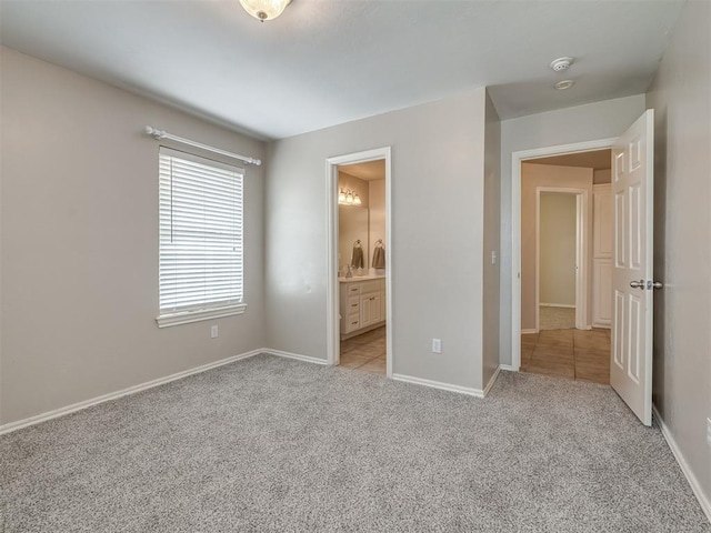 16104 Ledge Ln, Edmond, OK 73013 - unfurnished bedroom with light colored carpet, baseboards, and ensuite bath