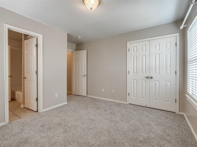 16104 Ledge Ln, Edmond, OK 73013 - unfurnished bedroom featuring carpet floors, a closet, baseboards, and multiple windows