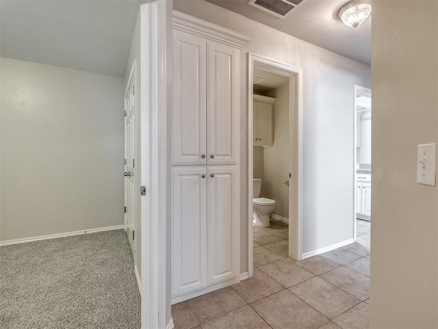 16104 Ledge Ln, Edmond, OK 73013 - hallway with light tile patterned floors and baseboards