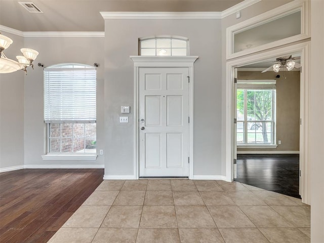 16104 Ledge Ln, Edmond, OK 73013 - entryway with ornamental molding, wood finished floors, a chandelier, and baseboards