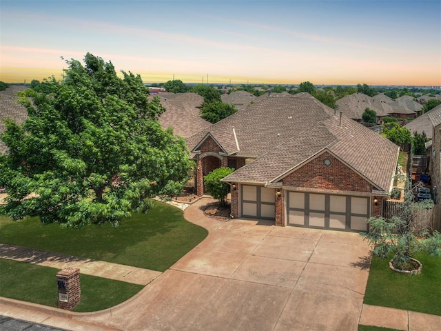 16104 Ledge Ln, Edmond, OK 73013 - view of front facade with a garage, brick siding, concrete driveway, and a shingled roof