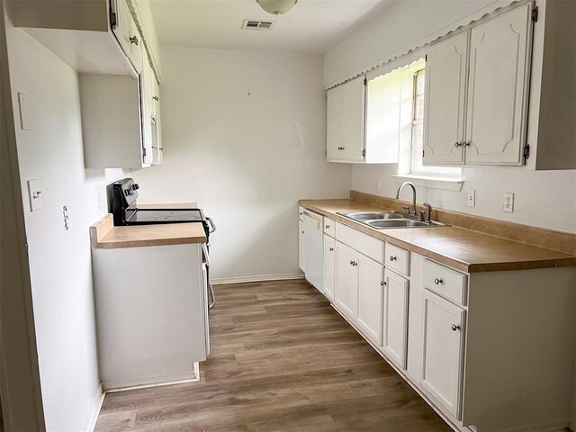 520 Dozer Rd, Sulphur, OK 73086 - kitchen with a sink, baseboards, wood finished floors, dishwasher, and white cabinetry