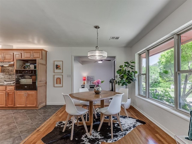 1738 Westchester Dr, Oklahoma City, OK 73120 - dining space featuring baseboards and dark wood-style flooring
