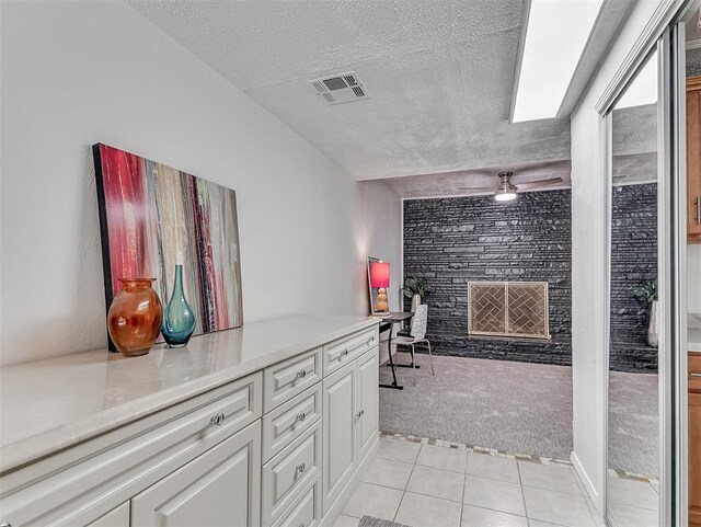 1738 Westchester Dr, Oklahoma City, OK 73120 - corridor featuring light carpet, a textured ceiling, and light tile patterned floors